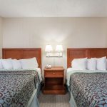 Two double beds in hotel room at Days Inn and Suites Wildwood